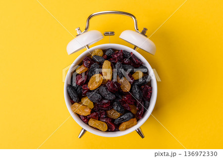 Dried cranberries, yellow and black sweet raisins as ingredients. Raisins and cranberries Dried cranberries, yellow and black sweet raisins as ingredients. Raisins and cranberries 136972330