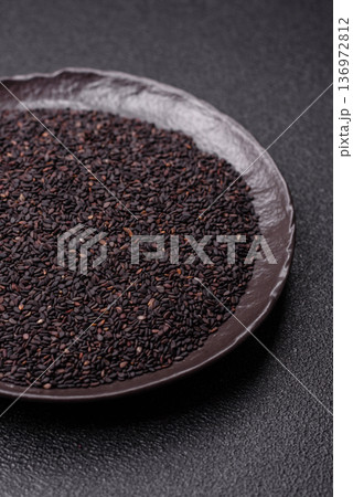 Black sesame seeds in a bowl, an ingredient for oil and healthy eating. Black sesame 136972812