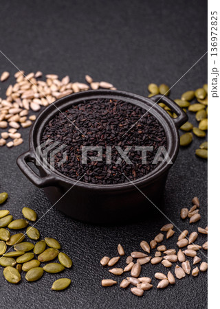 Black sesame seeds in a bowl, an ingredient for oil and healthy eating. Black sesame 136972825