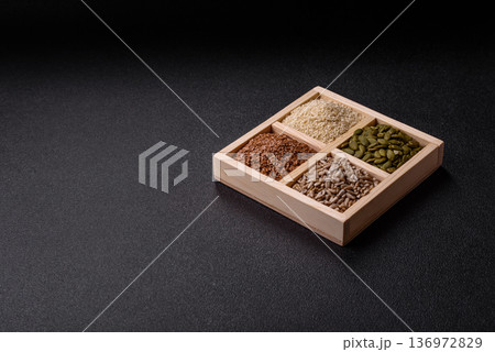 Flax, pumpkin, sunflower, and sesame seeds, ingredients for healthy eating 136972829