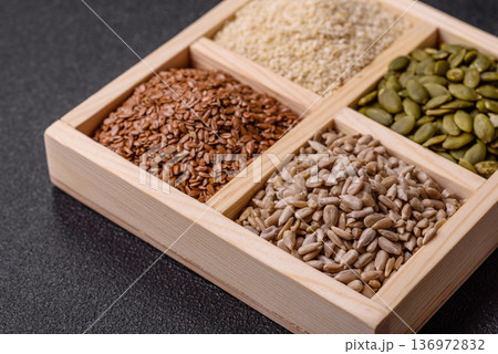 Flax, pumpkin, sunflower, and sesame seeds, ingredients for healthy eating Flax, pumpkin, sunflower, and sesame seeds, ingredients for healthy eating 136972832