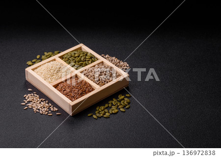 Flax, pumpkin, sunflower, and sesame seeds, ingredients for healthy eating Flax, pumpkin, sunflower, and sesame seeds, ingredients for healthy eating 136972838