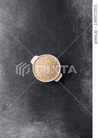 White sesame seeds in a bowl, an ingredient for oil and healthy eating. White sesame White sesame seeds in a bowl, an ingredient for oil and healthy eating. White sesame 136972855