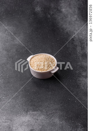 White sesame seeds in a bowl, an ingredient for oil and healthy eating. White sesame White sesame seeds in a bowl, an ingredient for oil and healthy eating. White sesame 136972856