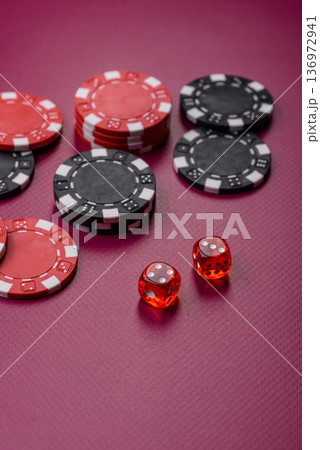 Casino dice and chips on a colored background, poker, gambling with bets. Dice and chips Casino dice and chips on a colored background, poker, gambling with bets. Dice and chips 136972941