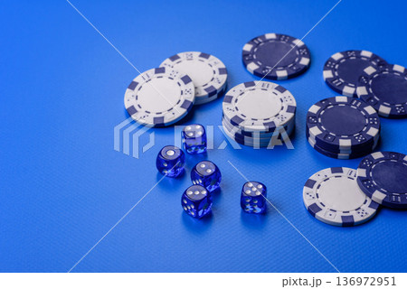 Casino dice and chips on a colored background, poker, gambling with bets. Dice and chips Casino dice and chips on a colored background, poker, gambling with bets. Dice and chips 136972951