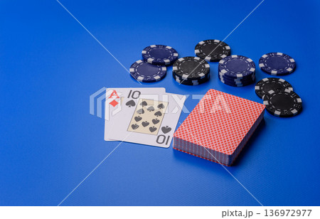 Casino, cards and chips on a colored background, poker and blackjack, gambling. Cards and chips Casino, cards and chips on a colored background, poker and blackjack, gambling. Cards and chips 136972977