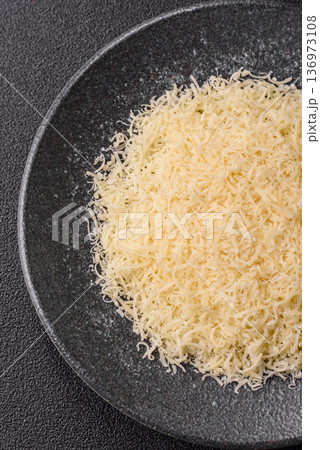 Grated Parmesan cheese as a cooking or baking ingredient. Grated Parmesan cheese 136973108