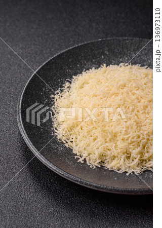 Grated Parmesan cheese as a cooking or baking ingredient. Grated Parmesan cheese 136973110