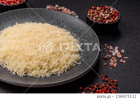 Grated Parmesan cheese as a cooking or baking ingredient. Grated Parmesan cheese 136973112