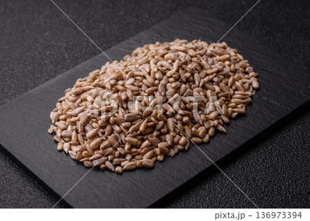 Shelled sunflower seed kernels, salted, roasted, or raw, are a healthy ingredient. Sunflower seeds 136973394