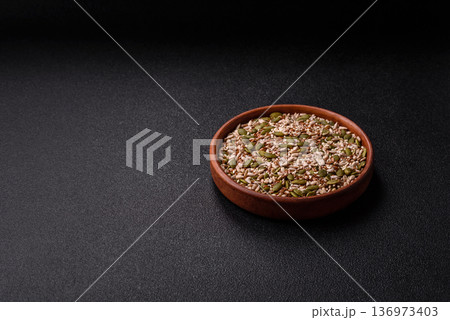 Shelled sunflower, sesame, pumpkin, and flaxseed kernels as ingredients for healthy food Shelled sunflower, sesame, pumpkin, and flaxseed kernels as ingredients for healthy food 136973403