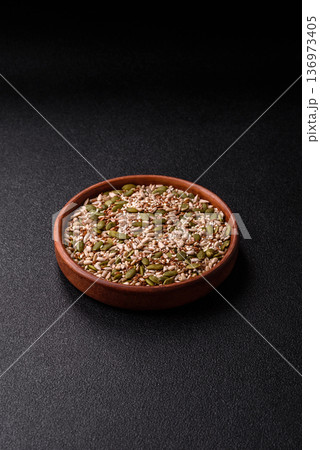 Shelled sunflower, sesame, pumpkin, and flaxseed kernels as ingredients for healthy food 136973405