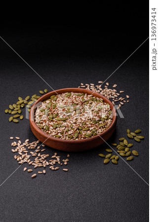 Shelled sunflower, sesame, pumpkin, and flaxseed kernels as ingredients for healthy food 136973414