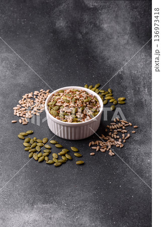 Shelled sunflower, sesame, pumpkin, and flaxseed kernels as ingredients for healthy food 136973418