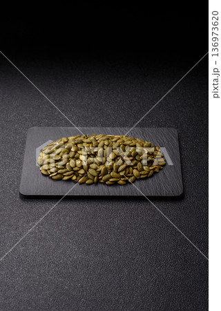 Shelled pumpkin seed kernels, salted, roasted, or raw, are a healthy ingredient. Pumpkin seeds 136973620