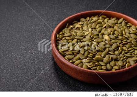 Shelled pumpkin seed kernels, salted, roasted, or raw, are a healthy ingredient. Pumpkin seeds 136973633