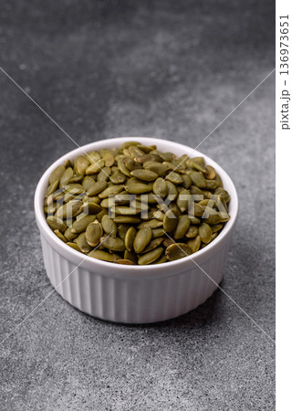 Shelled pumpkin seed kernels, salted, roasted, or raw, are a healthy ingredient. Pumpkin seeds 136973651