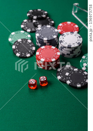 Casino dice and chips on a colored background, poker, gambling with bets. Dice and chips Casino dice and chips on a colored background, poker, gambling with bets. Dice and chips 136973758