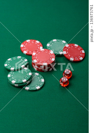 Casino dice and chips on a colored background, poker, gambling with bets. Dice and chips Casino dice and chips on a colored background, poker, gambling with bets. Dice and chips 136973761