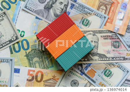Cargo containers on the euro and dollar background as a concept for goods export. Cargo containers Cargo containers on the euro and dollar background as a concept for goods export. Cargo containers 136974014