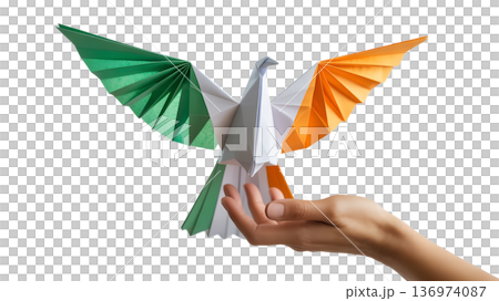 Delicate origami dove folded from the irish flag green, white, orange gently held in a hand, symbolizing peace and unity for ireland 136974087