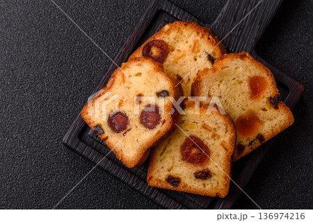 Fruit cake, a dessert with cherries, plums, and raisins for a festive Christmas table. Fruit cake Fruit cake, a dessert with cherries, plums, and raisins for a festive Christmas table. Fruit cake 136974216