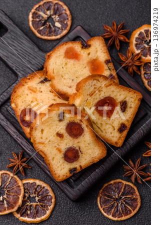 Fruit cake, a dessert with cherries, plums, and raisins for a festive Christmas table. Fruit cake Fruit cake, a dessert with cherries, plums, and raisins for a festive Christmas table. Fruit cake 136974219