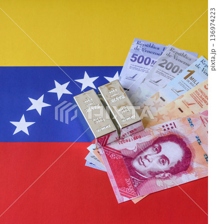A silver bar, white metal against a flag of venezuela, as a concept for the sales. A silver bar 136974223