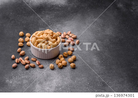 Roasted or raw cashew make a savory snack for a healthy, filling meal. Cashew nuts Roasted or raw cashew make a savory snack for a healthy, filling meal. Cashew nuts 136974301