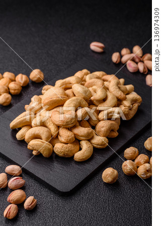 Roasted or raw cashew make a savory snack for a healthy, filling meal. Cashew nuts Roasted or raw cashew make a savory snack for a healthy, filling meal. Cashew nuts 136974309