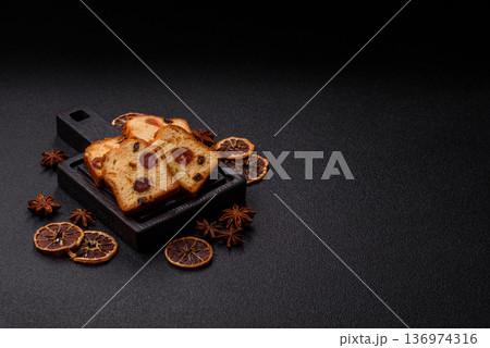 Fruit cake, a dessert with cherries, plums, and raisins for a festive Christmas table. Fruit cake Fruit cake, a dessert with cherries, plums, and raisins for a festive Christmas table. Fruit cake 136974316