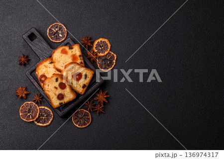 Fruit cake, a dessert with cherries, plums, and raisins for a festive Christmas table. Fruit cake Fruit cake, a dessert with cherries, plums, and raisins for a festive Christmas table. Fruit cake 136974317