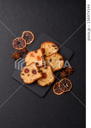 Fruit cake, a dessert with cherries, plums, and raisins for a festive Christmas table. Fruit cake Fruit cake, a dessert with cherries, plums, and raisins for a festive Christmas table. Fruit cake 136974344