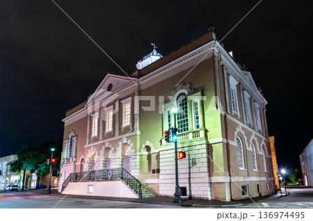 Night view of the illuminated historic Old Exchange and Provost Dungeon building at the corner of East Bay and Broad Streets in Charleston, South Carolina, United States. 136974495