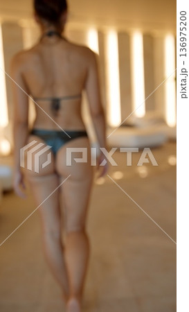 Silent spa walk. Calm woman moves quietly along peaceful spa hallway 136975200