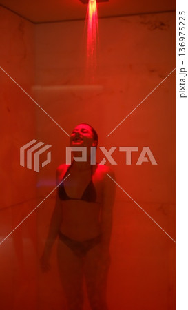 Female athlete performing post workout stretches in wellness setting 136975225