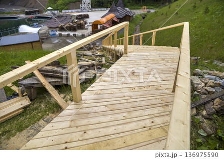 New wooden stairs outdoors. Carpenters work. New wooden stairs outdoors. Carpenters work. 136975590