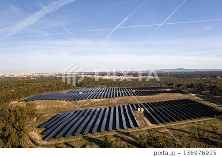 Aerial drone view of solar panels in lush fields 136976915