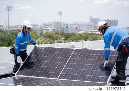 Caucasian worker team installing solar cell for sustainable energy power. Caucasian worker team installing solar cell for sustainable energy power. 136978541