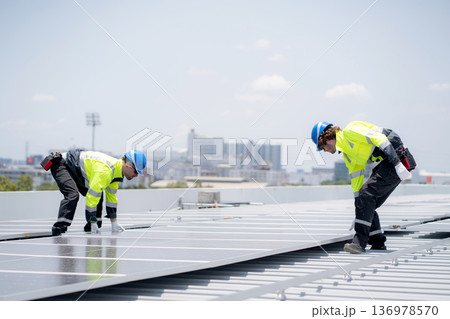 Caucasian worker team installing solar cell for sustainable energy power. 136978570
