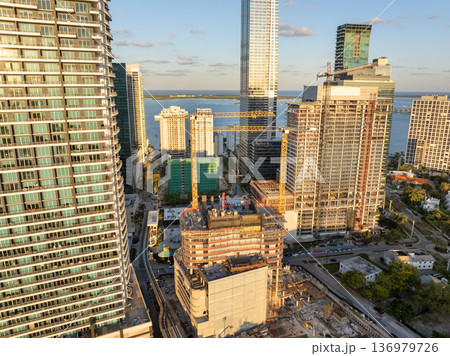 Miami, Florida. Developing American megapolis with new high-rise buildings under construction at sunset Miami, Florida. Developing American megapolis with new high-rise buildings under construction at sunset 136979726