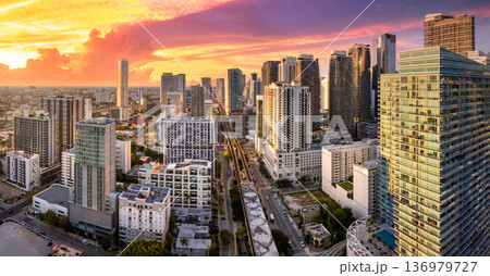 Aerial view of downtown office district of Miami Brickell in Florida, USA. High commercial and residential skyscraper buildings in modern American megapolis at sunset Aerial view of downtown office district of Miami Brickell in Florida, USA. High commercial and residential skyscraper buildings in modern American megapolis at sunset 136979727
