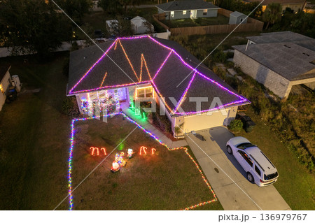 Festive yard display with glowing lights and Christmas decorations at a Florida family home. New Year holiday joy. Festive yard display with glowing lights and Christmas decorations at a Florida family home. New Year holiday joy. 136979767