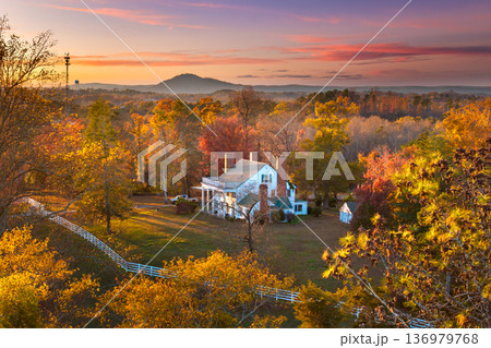 Large countryside houses scattered across the colorful North Carolina landscape. Appalachian mountain slopes covered with vibrant fall foliage. Large countryside houses scattered across the colorful North Carolina landscape. Appalachian mountain slopes covered with vibrant fall foliage. 136979768