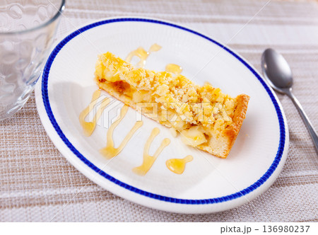 Dutch apple pie slice with maple syrup on plate Dutch apple pie slice with maple syrup on plate 136980237