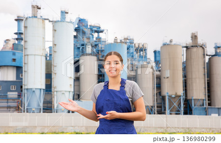 Smiling young girl posing near factory Smiling young girl posing near factory 136980299