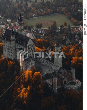 Historic castle surrounded by vibrant autumn foliage in a scenic landscape 136980329