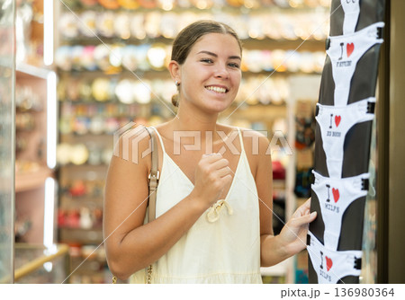 Happy girl chooses panties with different funny inscriptions 136980364