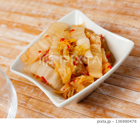 Portion of kimchi served in glass bowl 136980478